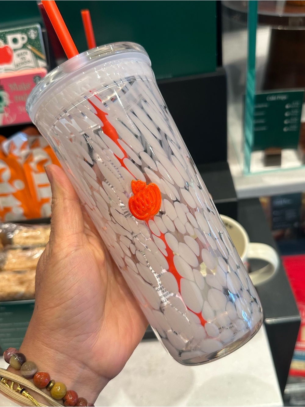 Starbucks 16-ounce PSL glass cold cup pumpkin detail with a matching straw.